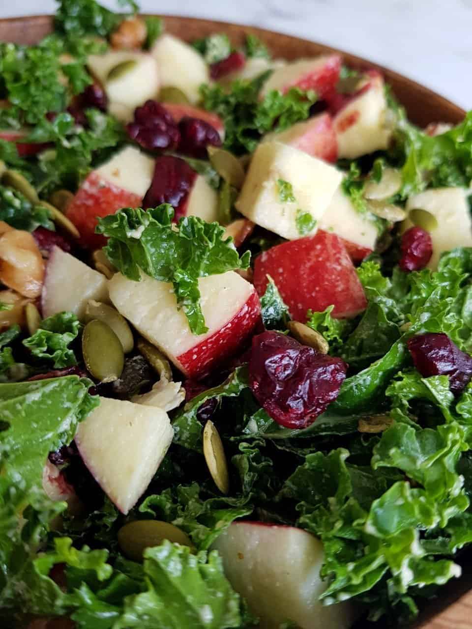 Kale and apple salad in a wooden bowl.
